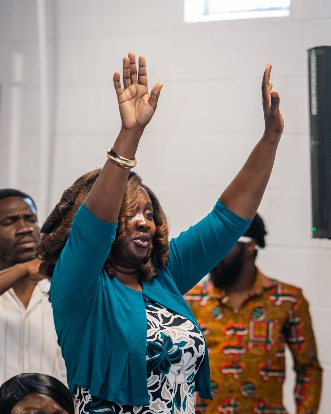 A woman worshipping with both hands raised