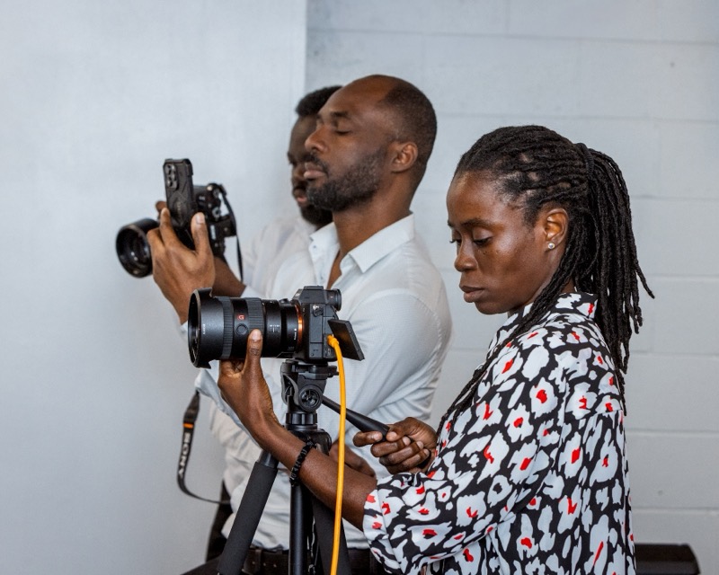 Media team members filming and photographing a Sunday service